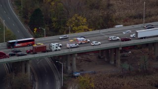 AX121_007E - 5.5K aerial stock footage track ambulance on busy freeway at Sunset in Autumn, Bayonne, New Jersey
