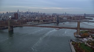 AX121_023 - 5.5K aerial stock footage approach the Brooklyn and Manhattan Bridges at twilight in New York City