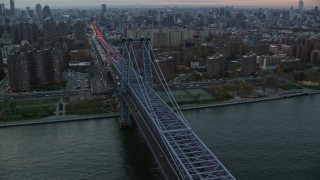 AX121_045 - 5.5K aerial stock footage orbit Williamsburg Bridge at twilight in New York City