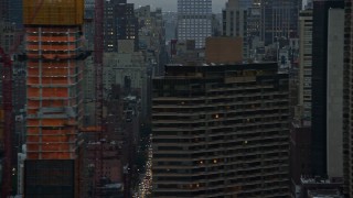 AX121_051E - 5.5K aerial stock footage of city streets in Midtown at twilight in New York City