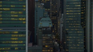 AX121_052E - 5.5K aerial stock footage of passing city streets and Midtown high-rises at twilight in New York City