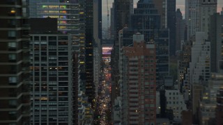 AX121_060E - 5.5K aerial stock footage flyby high-rises and busy streets on Upper East Side at twilight in New York City
