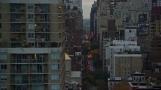 AX121_071E - 5.5K aerial stock footage flyby city canyons in Midtown at twilight in New York City
