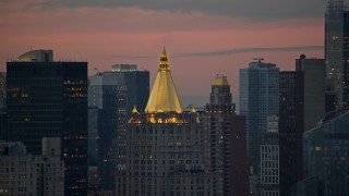 AX121_076 - 5.5K aerial stock footage of the roof of the New York Life Building in Midtown at twilight in New York City