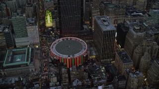 AX121_084E - 5.5K stock footage aerial video approach and orbit Madison Square Garden at twilight in New York City