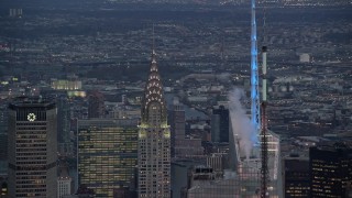AX121_089E - 5.5K aerial stock footage orbit top of Chrysler Building at twilight in Midtown, New York City