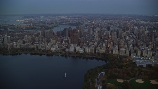AX121_096 - 5.5K aerial stock footage orbit Upper East Side skyscrapers near Central Park at twilight in New York City