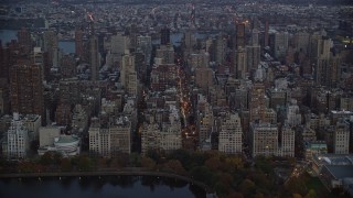 AX121_097 - 5.5K aerial stock footage approach Upper East Side apartment buildings at twilight in New York City