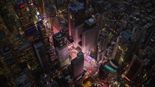 AX121_105E - 5.5K aerial stock footage of bright lights of Times Square at twilight in Midtown, New York City