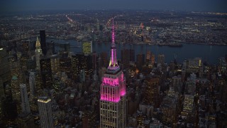 AX121_108 - 5.5K aerial stock footage orbit top of Empire State Building at twilight in Midtown, New York City