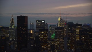 AX121_118 - 5.5K aerial stock footage of Midtown skyscrapers at twilight in New York City