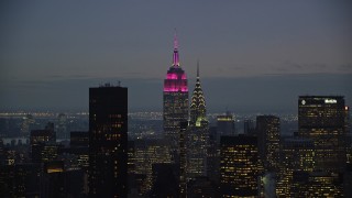 AX121_119E - 5.5K aerial stock footage of Empire State and Chrysler Buildings at twilight in Midtown, New York City