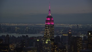 AX121_122E - 5.5K aerial stock footage orbit the Empire State and Chrysler Buildings at twilight in Midtown Manhattan, New York City