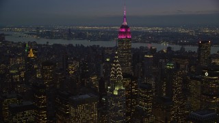 AX121_124E - 5.5K aerial stock footage of the Empire State and Chrysler Buildings at twilight in New York City