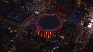 AX121_129 - 5.5K aerial stock footage orbit of Madison Square Garden at twilight in Midtown Manhattan, New York City