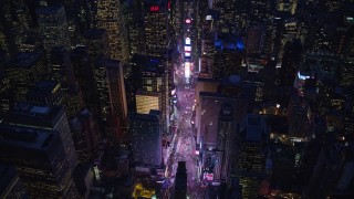 AX121_133E - 5.5K aerial stock footage orbit Times Square and high-rises at Night in Midtown, New York City