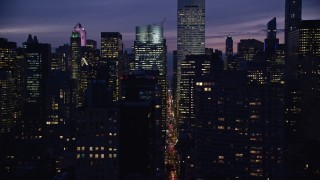 AX121_147 - 5.5K aerial stock footage of Midtown city canyons at Night in New York City