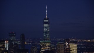 AX121_156E - 5.5K aerial stock footage of the top of Freedom Tower at Night in Lower Manhattan, New York City