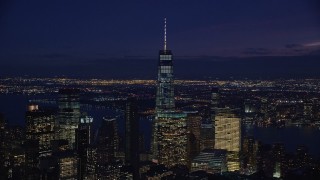 AX121_159E - 5.5K aerial stock footage of Freedom Tower in Lower Manhattan, New York City at Night