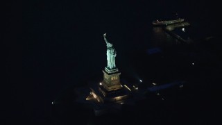 AX121_167 - 5.5K aerial stock footage orbit the Statue of Liberty at Night in New York