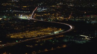 AX121_197 - 5.5K stock footage aerial video orbit heavy traffic on New Jersey Turnpike at Night