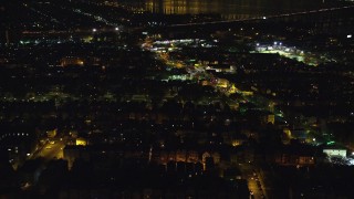 AX121_200E - 5.5K aerial stock footage of a suburban neighborhood at Night in Jersey City, New Jersey