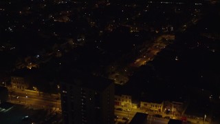 AX122_005E - 5.5K aerial stock footage fly over suburban homes in Jersey City, New Jersey at Night