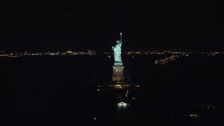 AX122_016E - 5.5K aerial stock footage of orbiting side and back of Statue of Liberty at Night in New York