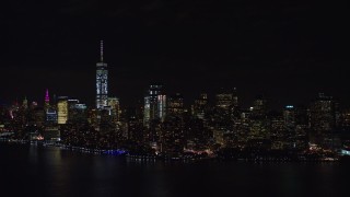 AX122_026E - 5.5K aerial stock footage of approaching Lower Manhattan at Night in New York City