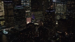AX122_030E - 5.5K aerial stock footage of the World Trade Center towers at Night, reveal Memorial in Lower Manhattan, New York City