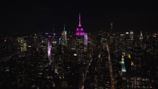 AX122_052E - 5.5K stock footage aerial video of a wide orbit of the Empire State Building at Night in Midtown Manhattan, NYC