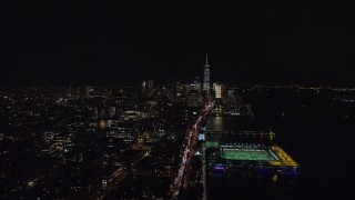 AX122_056E - 5.5K aerial stock footage of heavy traffic on West Street to Lower Manhattan at Night in NYC