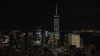 AX122_059E - 5.5K aerial stock footage approach and orbit Freedom Tower and Lower Manhattan at Night in NYC