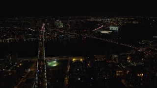 AX122_064E - 5.5K aerial stock footage of an approach Brooklyn and Manhattan Bridge at Night in NYC