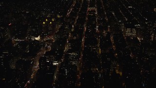 AX122_104 - 5.5K aerial stock footage orbit hospital and city streets in Gramercy at Night in NYC