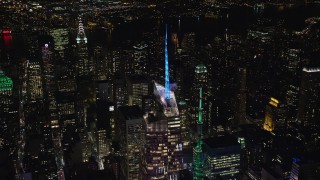 AX122_118E - 5.5K aerial stock footage orbit the top of Bank of America Tower at Night in Midtown, New York City