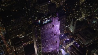 AX122_122E - 5.5K stock footage aerial video approach Rockefeller Center at Night in Midtown Manhattan, New York City