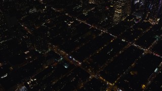 AX122_128 - 5.5K aerial stock footage orbit city streets in Hell's Kitchen at Night in Midtown Manhattan, New York City