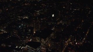 AX122_145E - 5.5K aerial stock footage of office buildings and Washington Square Arch at Night in Greenwich Village, NYC