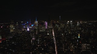 AX122_149E - 5.5K aerial stock footage approach unlit Empire State Building at Night in Midtown, New York City