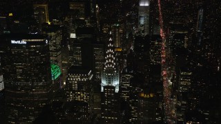 AX122_156E - 5.5K aerial stock footage of Chrysler Building and Lexington Avenue at Night in Midtown, NYC