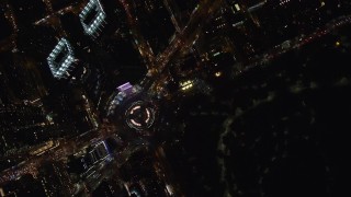 AX122_180 - 5.5K aerial stock footage of bird's eye orbit of Columbus Circle at Night in Midtown Manhattan, NYC