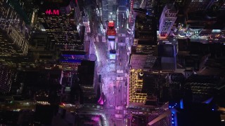 AX122_187E - 5.5K stock footage aerial video tilt to bird's eye view of famous Times Square at Night in Midtown, NYC