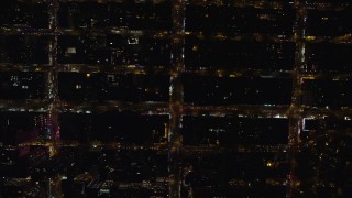 AX122_192E - 5.5K aerial stock footage of a bird's eye of city streets in Chelsea, New York City at Night