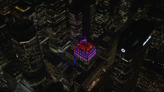 AX122_205E - 5.5K aerial stock footage orbit the Helmsley Building in Midtown, New York City at Night