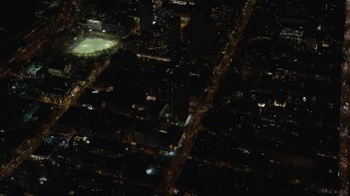 AX122_215 - 5.5K aerial stock footage orbit Hell's Kitchen apartment buildings and streets at Night in Midtown, New York City