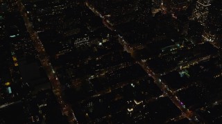 AX122_216E - 5.5K aerial stock footage orbit Hell's Kitchen streets and apartments at Night in Midtown Manhattan, New York City