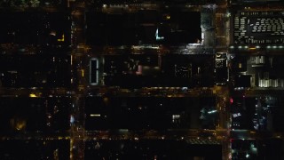 AX122_219E - 5.5K aerial stock footage bird's eye view of Hell's Kitchen streets at Night in Midtown Manhattan, New York City