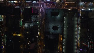 AX122_222E - 5.5K aerial stock footage of a bird's eye of 42nd and 43rd streets at Night in Midtown Manhattan, New York City