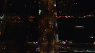 AX122_242E - 5.5K aerial stock footage of a bird's eye of heavy traffic off Williamsburg Bridge to Delancey Street at Night, Lower East Side, NYC